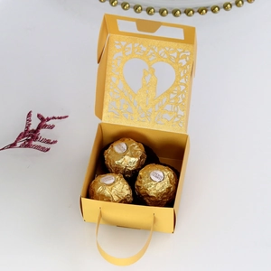 Detail of laser-cut gold wedding gift box with tree of life design and gold handle