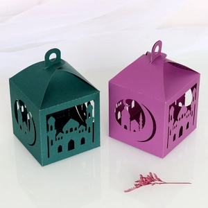 Detail of laser-cut Ramadan paper gift boxes with mosque and crescent moon patterns