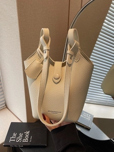 Elegant off-white lychee leather bucket bag with top handle and magnetic closure design