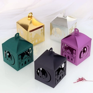 Detail of laser-cut paper gift boxes with star and moon patterns for festive decoration