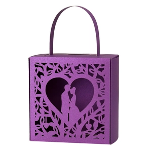 Detail of purple laser-cut gift box with romantic heart and couple silhouette pattern