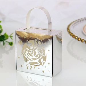 Detail of silver laser-cut gift box featuring intricate rose patterns and metallic finish