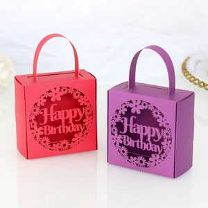 Detail of laser-cut Happy Birthday gift boxes in red and purple cardstock with floral pattern