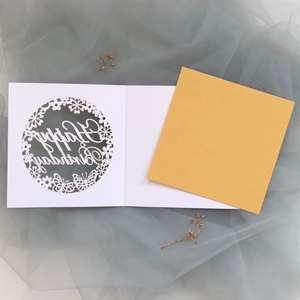 Detailed laser-cut birthday card featuring butterfly patterns and a yellow envelope