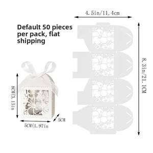 Detail view of white laser-cut favor box with hibiscus patterns and ribbon closure