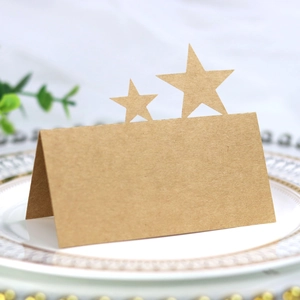 Close-up of kraft paper place card with star cutout on a white decorative plate