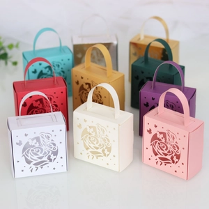 Detailed laser-cut gift boxes with intricate butterfly and rose patterns in various colors