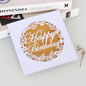 Close-up of laser-cut butterfly hollow pattern and Happy Birthday gold insert card
