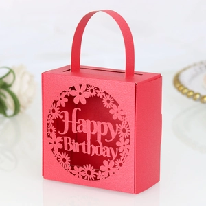 Macro detail of red laser-cut candy box with Happy Birthday floral engraving
