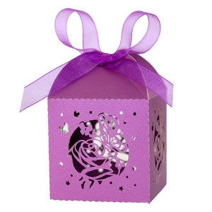 Detail of purple laser-cut wedding favor box with rose and butterfly patterns