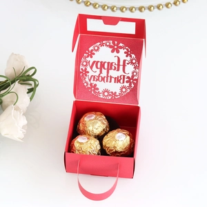 Detail of red hollow laser-cut Happy Birthday candy gift box with floral pattern