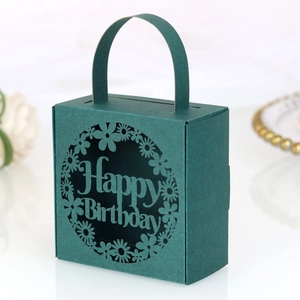 Detailed laser-cut Happy Birthday lettering on dark green paper party gift box