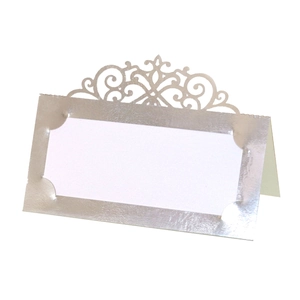 Macro shot of silver laser-cut place card with ornate European hollow patterns