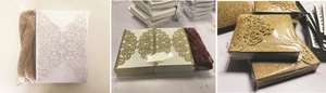 Detail of laser-cut wedding invitations featuring elegant hollow patterns and glitter finish