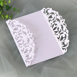 Close-up of laser-cut floral wedding invitation cover with elegant pearl paper texture