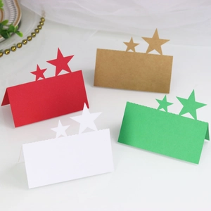 Close-up of laser-cut star place cards in red, green, white, and brown cardstock