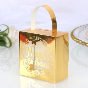 Close-up of golden laser-cut birthday candy gift box with Happy Birthday floral design
