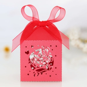 Detailed laser-cut red wedding favor box with rose patterns and matching silk ribbon bow