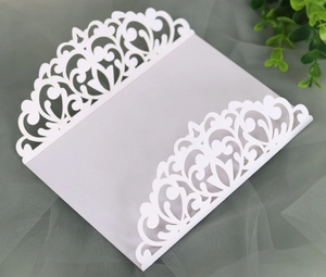 Intricate laser-cut floral pattern detail on white pearlescent paper wedding invitation