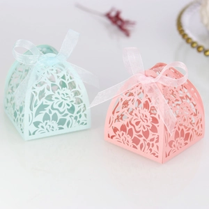 Detail of laser-cut floral wedding gift box with elegant organza ribbon and bow