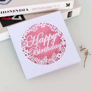 Close-up of laser-cut butterfly floral Happy Birthday card with elegant pink insert