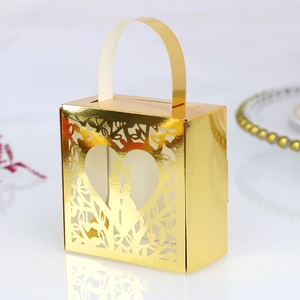 Detailed laser-cut golden wedding candy box featuring a romantic couple silhouette