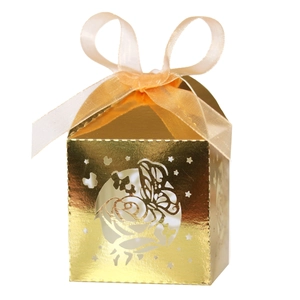 Detail of laser-cut gold candy box with rose and butterfly motifs and ribbon