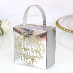 Macro detail of silver mirror birthday candy box with laser-cut Happy Birthday hollow design