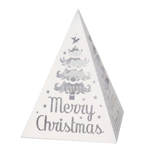 White Christmas pyramid lantern with cutout star and tree motifs on a glitter surface