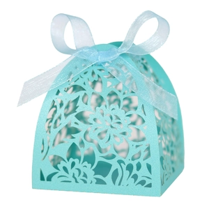 Detailed laser-cut floral patterns on a teal wedding candy box with a blue ribbon bow