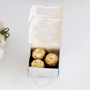 Macro view of white laser-cut Happy Birthday gift box with hollow floral patterns