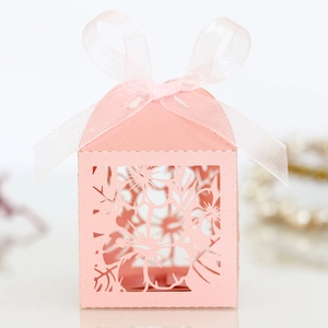 Laser cut hollow pink candy box with elegant floral pattern and matching ribbon bow