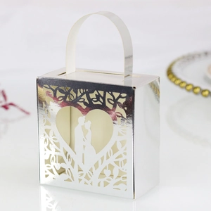 Detailed silver laser-cut wedding favor box with heart and couple silhouette design