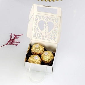 Laser-cut white wedding favor box showing couple silhouette and internal candy capacity