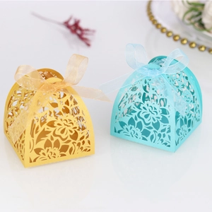 Detailed laser-cut hollow floral candy boxes in gold and blue with organza ribbon bows