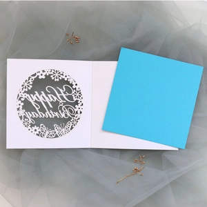 Laser-cut birthday card featuring a white hollow butterfly pattern with a blue insert card