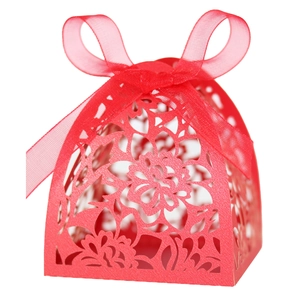 Red laser-cut floral wedding candy box with an elegant ribbon bow on a white background