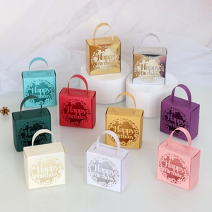Close-up of laser-cut 'Happy Birthday' candy gift boxes in nine assorted metallic colors