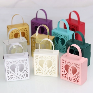 Laser-cut gift boxes with heart silhouettes and tree motifs in multiple colors