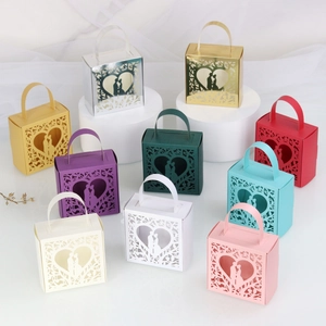 Laser cut favor boxes with heart silhouettes in various colors for wedding candy gifts
