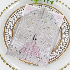 Detail of silver glitter laser cut wedding invitation with floral insert and porch design