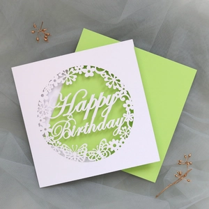 Detail of laser-cut butterfly and flower patterns on a Happy Birthday card sleeve