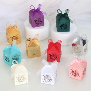Laser cut hollow wedding candy boxes with rose and butterfly patterns in various colors