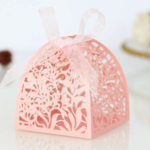 Detail view of pink laser-cut floral gift box with a delicate matching ribbon bow