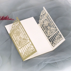 Detailed laser-cut glitter invitations with intricate gate patterns on mesh background