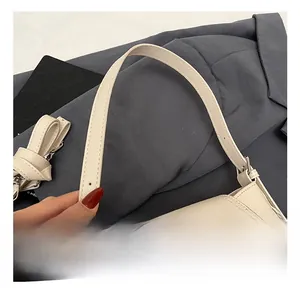 Gros plan d'un sac seau en cuir beige avec un fermoir rotatif en métal de style rétro