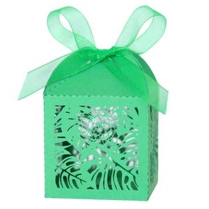 Laser-cut emerald green favor box with tropical leaf patterns and matching silk ribbon bow