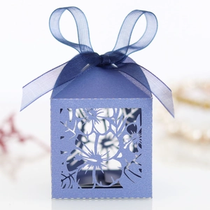 Detailed laser-cut floral pattern and lavender ribbon on a purple gift box