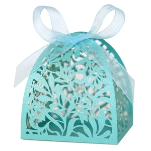 Elegant sky blue laser cut favor box with floral patterns and a satin ribbon bow