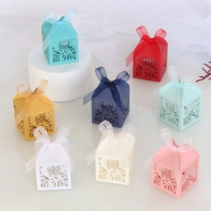 Detailed laser-cut hollow gift boxes with intricate leaf patterns and ribbon bows